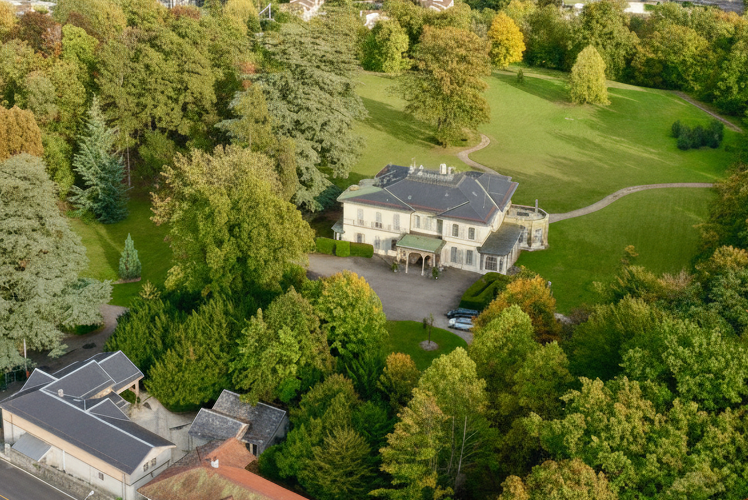 Aerial view of Les Ormeaux, surrounded by trees and lawns in Pregny-Chambésy, Switzerland
