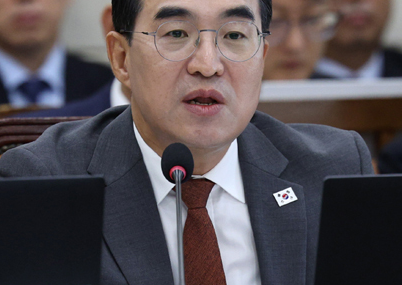 회의장에서 마이크 앞에 앉아 발언하는 박홍근 장관