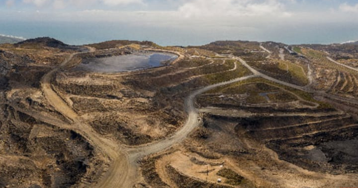 Terraced open-pit workings and winding roads at Stockton Mine.