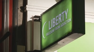 A green Liberty sign mounted outside a building.