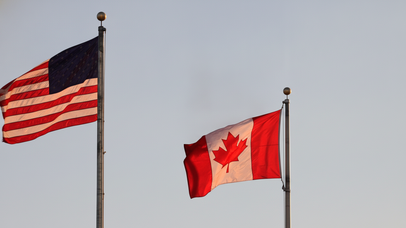 U.S. and Canadian flags waving on flagpoles.