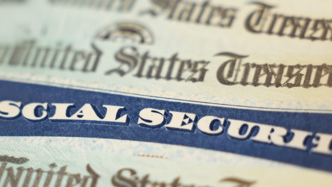 A close-up of a Social Security card among U.S. Treasury checks.