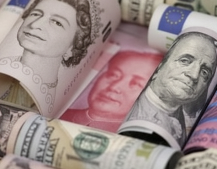 Rolled banknotes from several currencies arranged together